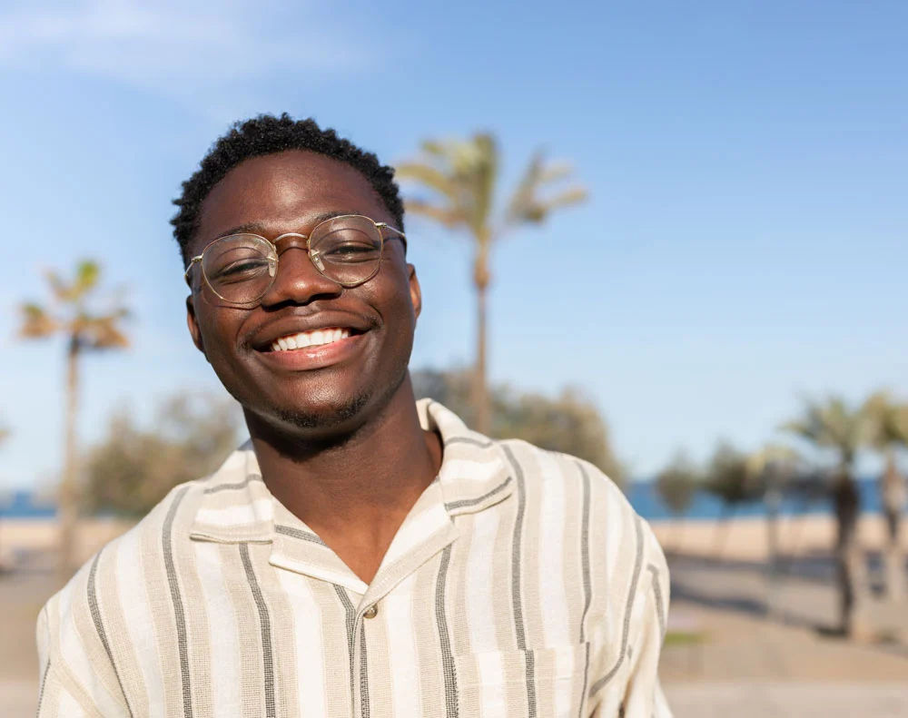 Portrait,of,young,happy,and,smiling,black,man,wearing,glasses
